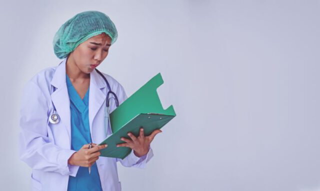 doctor looking at clipboard