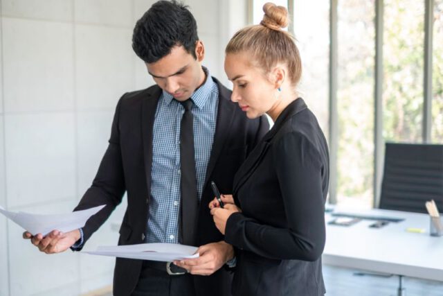 insurance agents discussing paperwork
