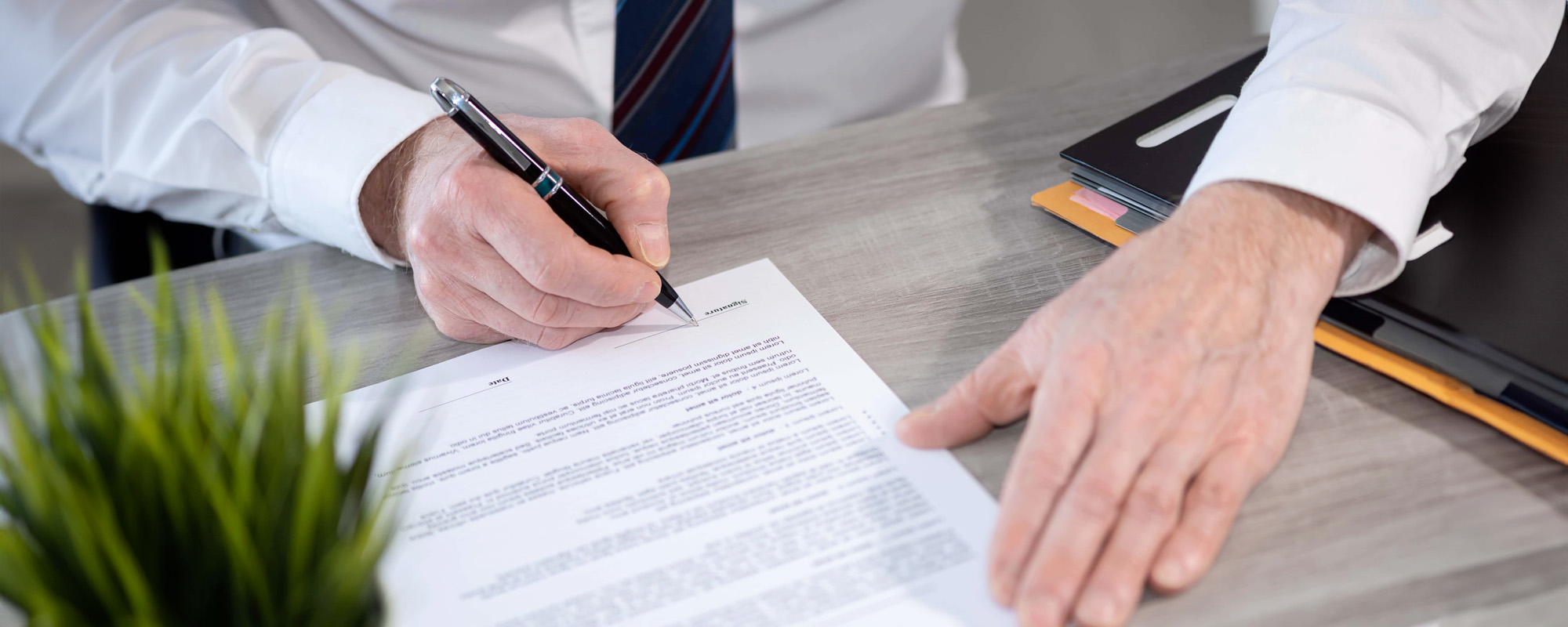Hand of businessman signing a document