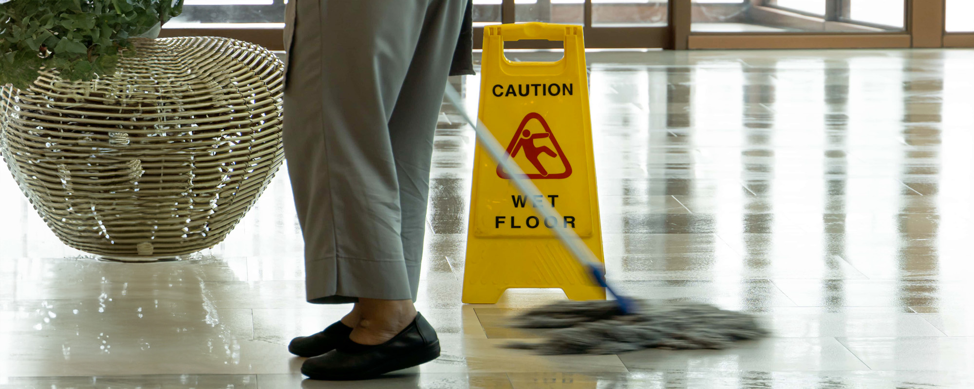Mopping wet floor in lobby hotel. Background for caution wet floor