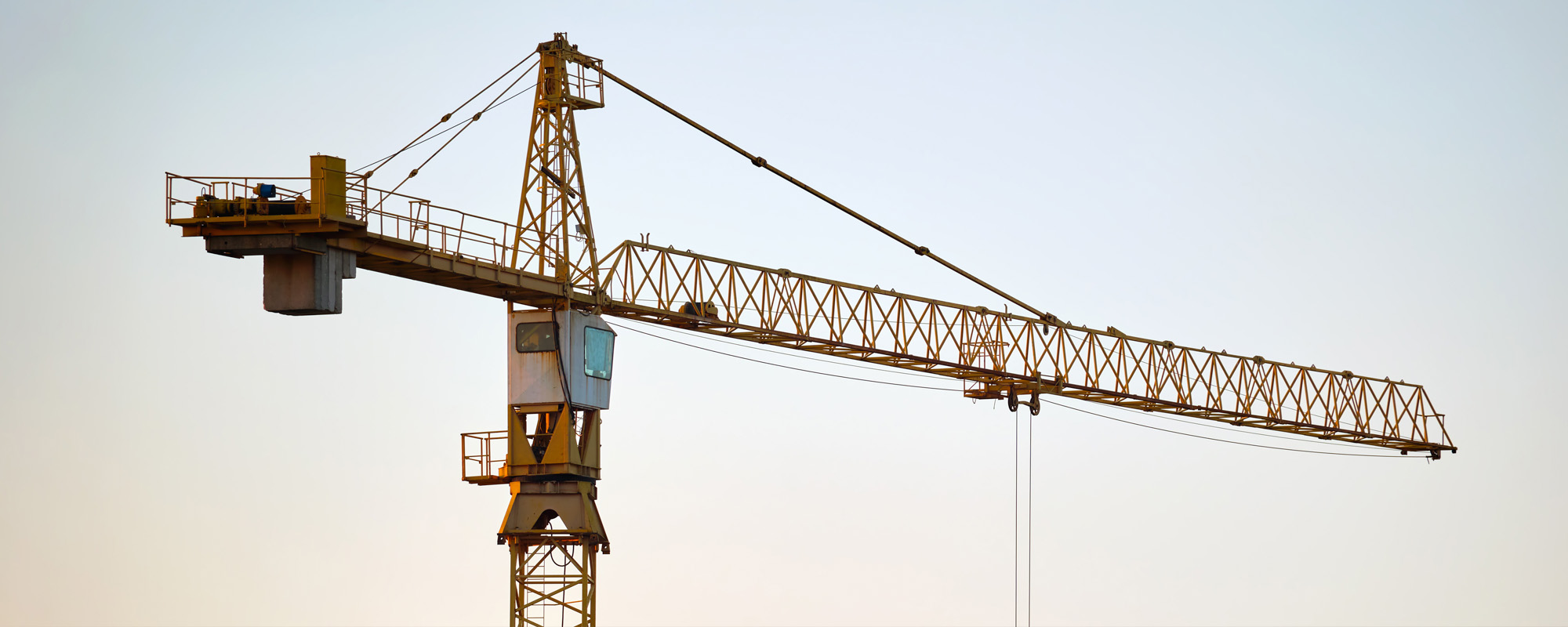 Tower crane at high residential apartment buildings construction site