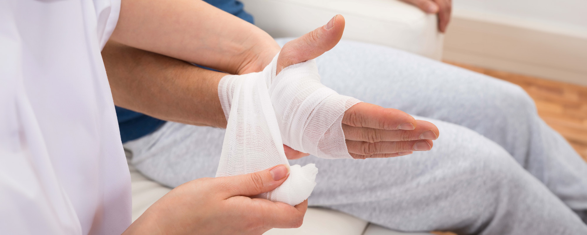 nurse bandaging patients hand