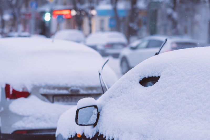 snowy cars in a parking lot