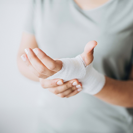 woman with gauze bandage wrapped around her hand
