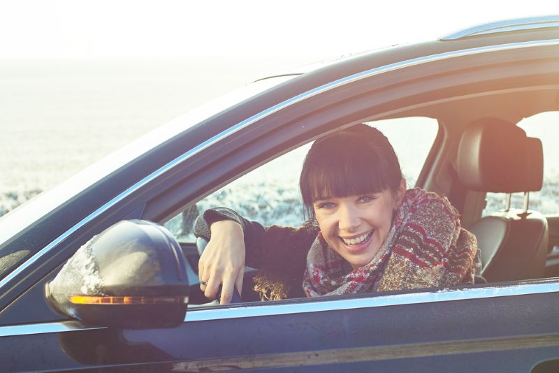 woman smiling driving in the cold weather