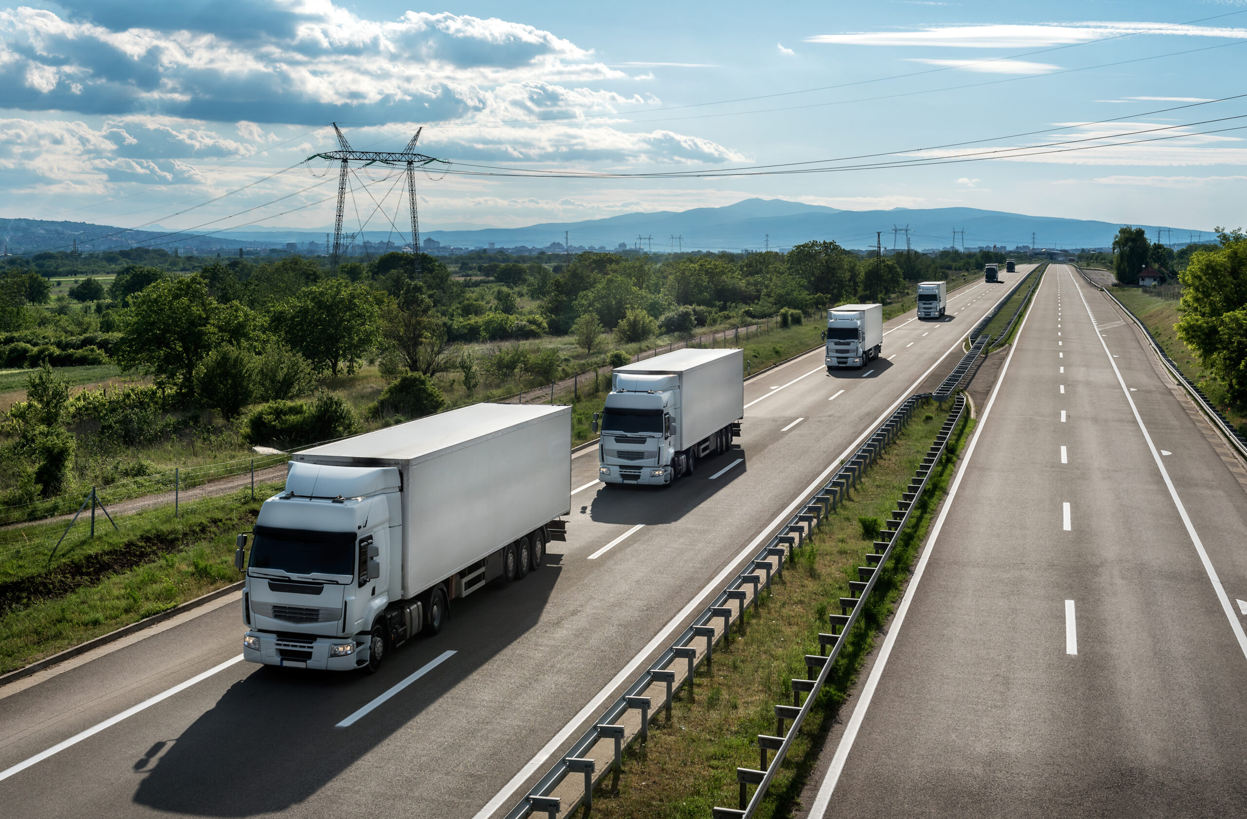 Transportation trucks passing by on a country highway
